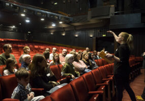 children and families sit in the theatre stalls for a presentation
