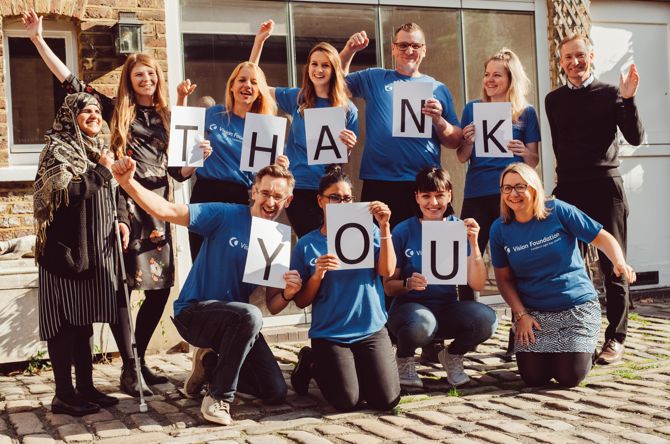 Image shows the Vision Foundation team holding up a 'Thank you' sign