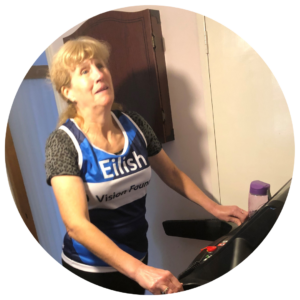 Eilish in a Vision Foundation running vest on her treadmill.