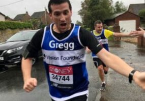 Gregg and Ian are taking part in 2020's virtual London Marathon. In this image they've swapped the crowds of supporters for some friendly neighbours, just out of shot are two arms reaching out to give the runners a high five.