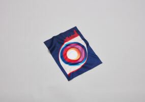The latest Cubitts lens cloth. A dark blue cloth with a colourful graphic of an eye.