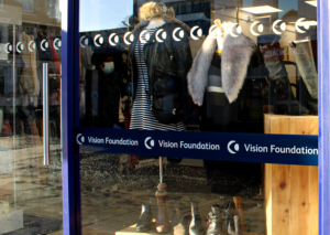 West Norwood shop window, with opaque logos to show the glass and VF logo branding across