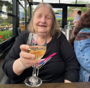 Carole, a visually impaired mature woman, enjoying a glass of wine on her birthday (her favourite image)