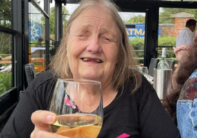 Carole, a visually impaired mature woman, enjoying a glass of wine on her birthday (her favourite image)