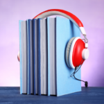 Stack of books with headphones put on top of them.