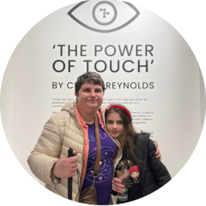 Charmaine and Alex standing together at "The Power of Touch" art exhibition.