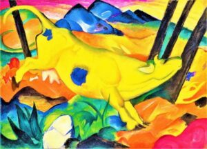 Franz Marc's Yellow Cow. A colour print of a bright yellow cow kicking its hind legs. In the background are blue peaked mountains and yellow/orange rolling heels.  